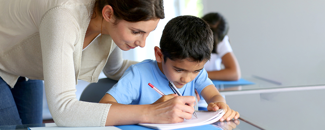 Teacher helping young student