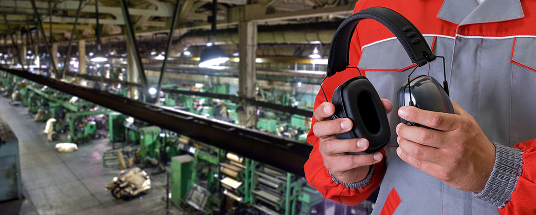 worker with ear protection in manufacturing facility