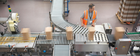 Factory worker at conveyor belt