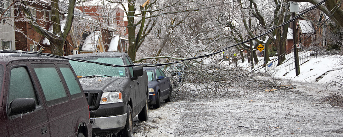 Damage to street and cars caused by winter storm