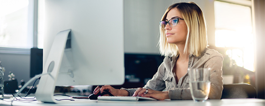 Woman at computer watching a training video