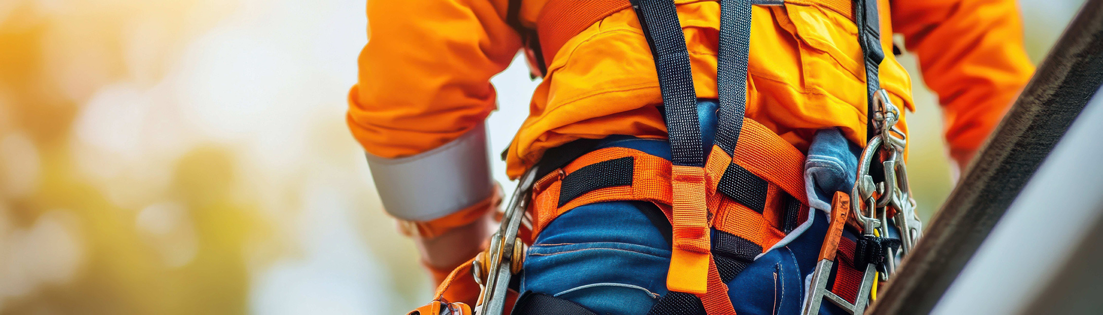 Worker at heights wearing safety harness
